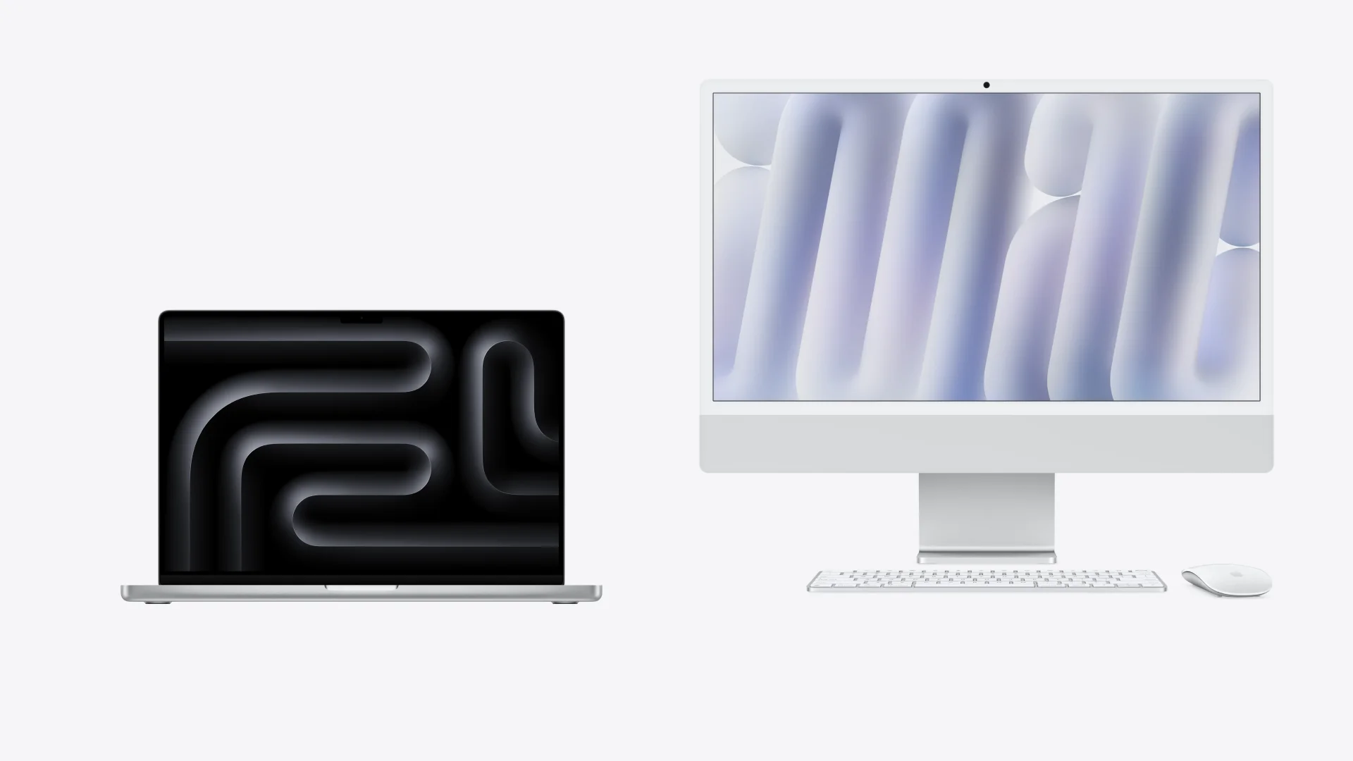 Otvoren MacBook Pro pored iMac računara, tastature i miša na svetloj pozadini